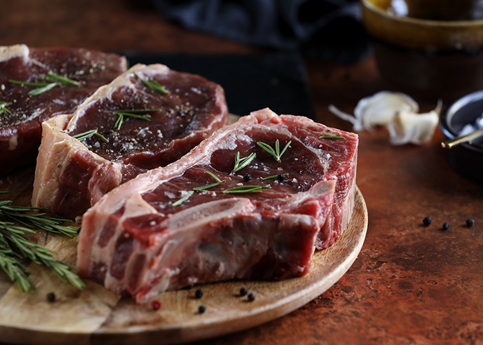 Prime 30-day aged beef and dry-aged steak cuts on a wooden platter